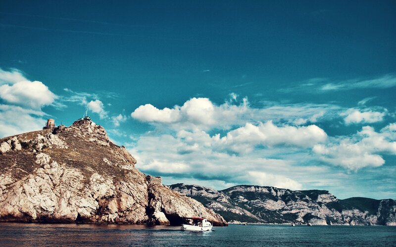 Coastal cliffs with boat and tower