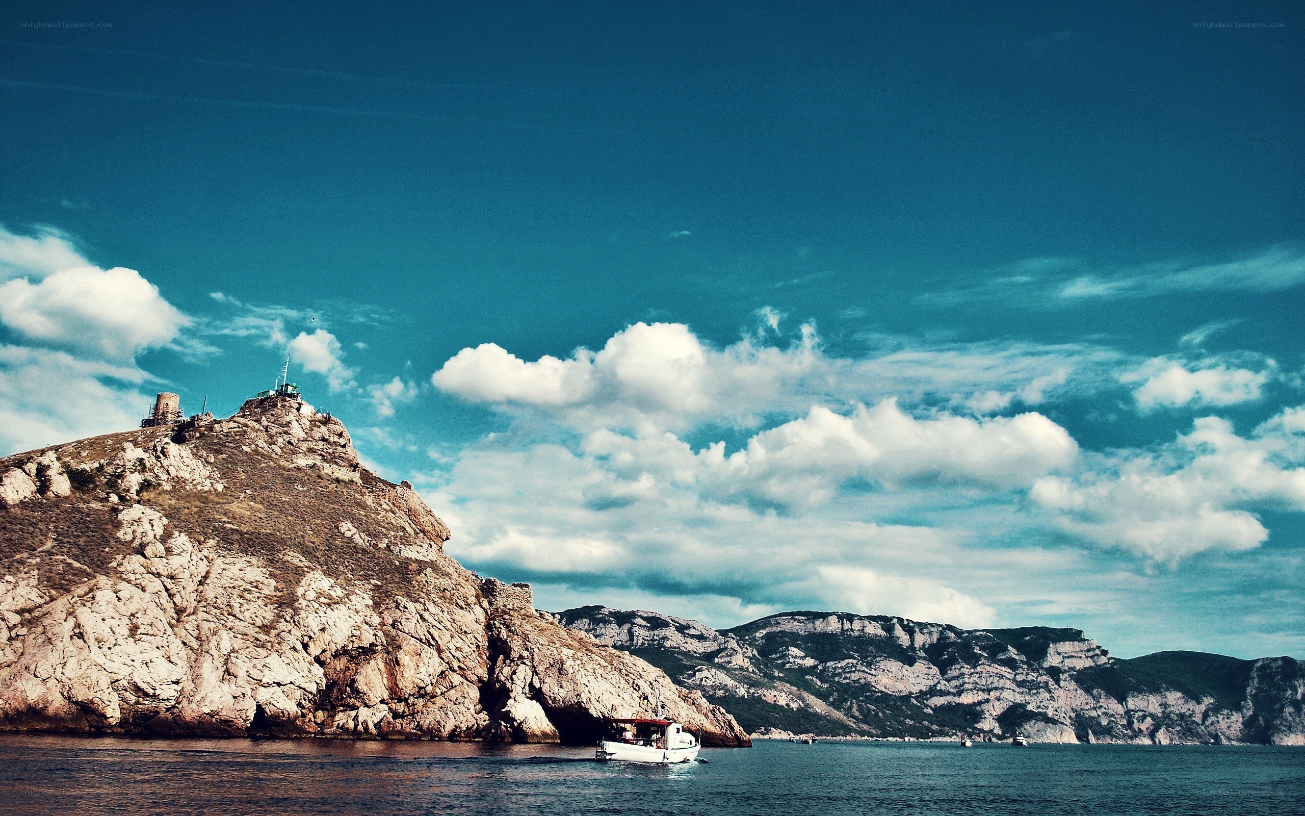 Coastal cliffs with boat and tower