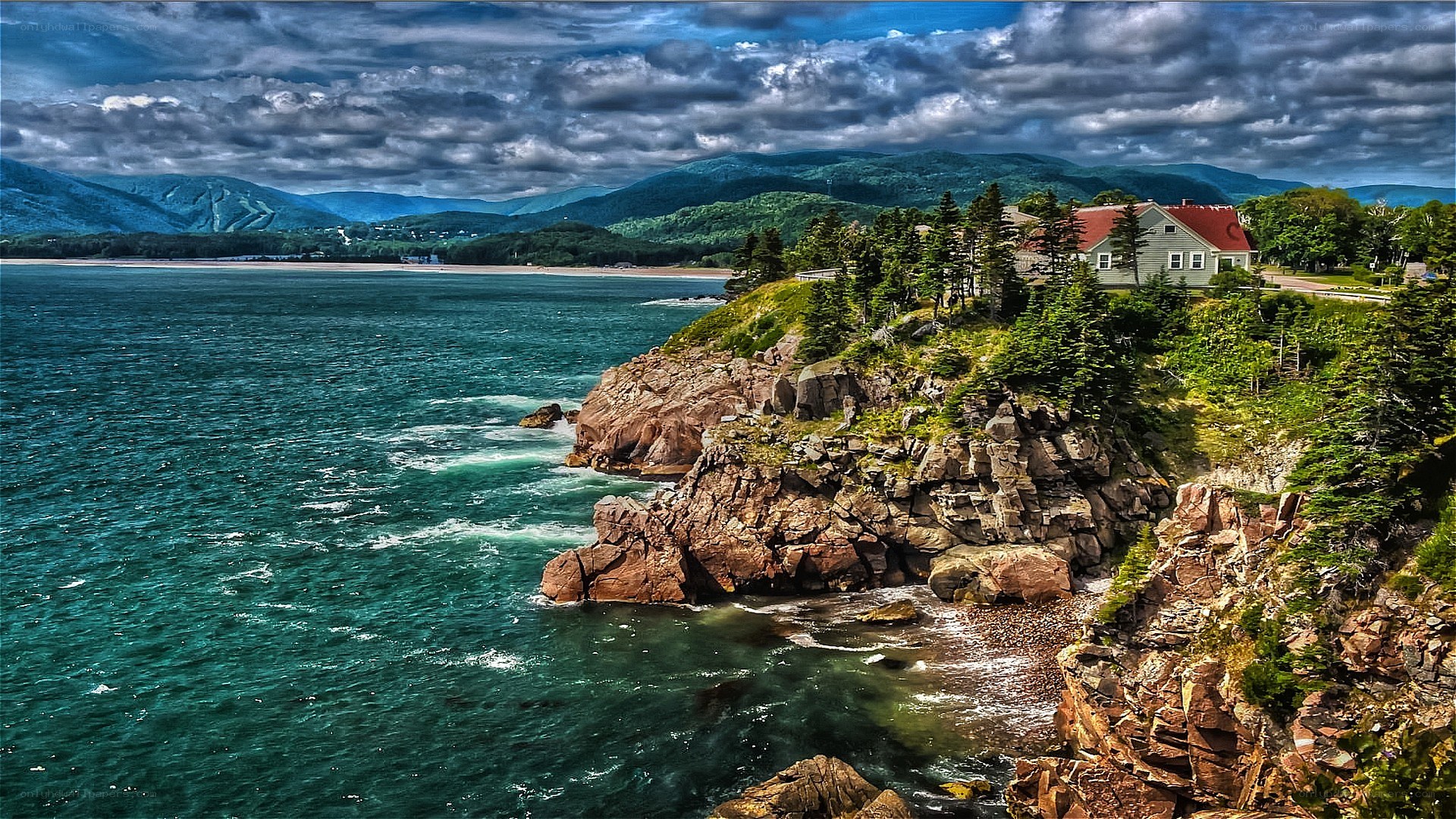 coastal cliffs with house and mountains
