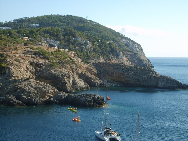 coastal cove with sailboat