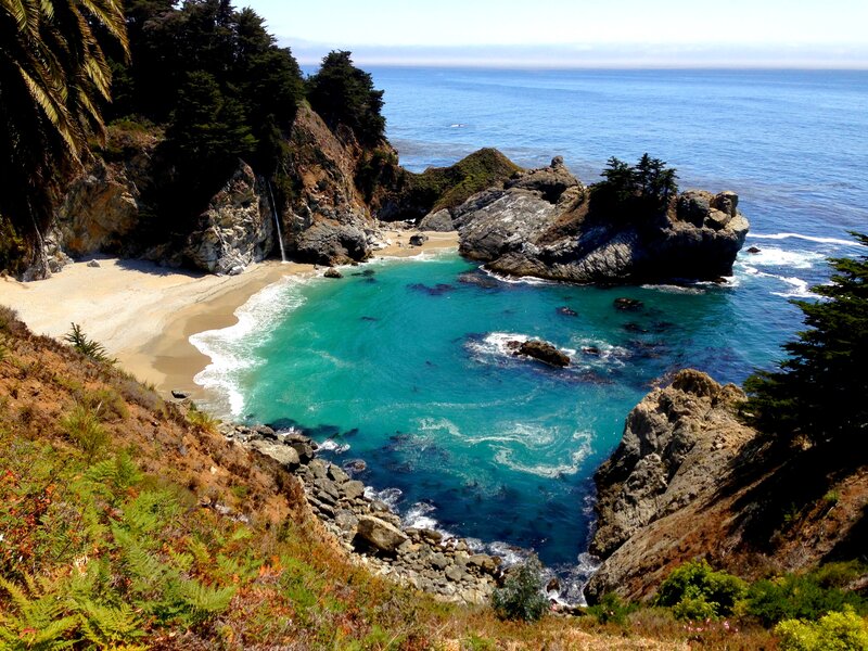 Coastal Cove with Waterfall — Blue, Serene, Afternoon, Photograph, Beach, Rocks, Trees