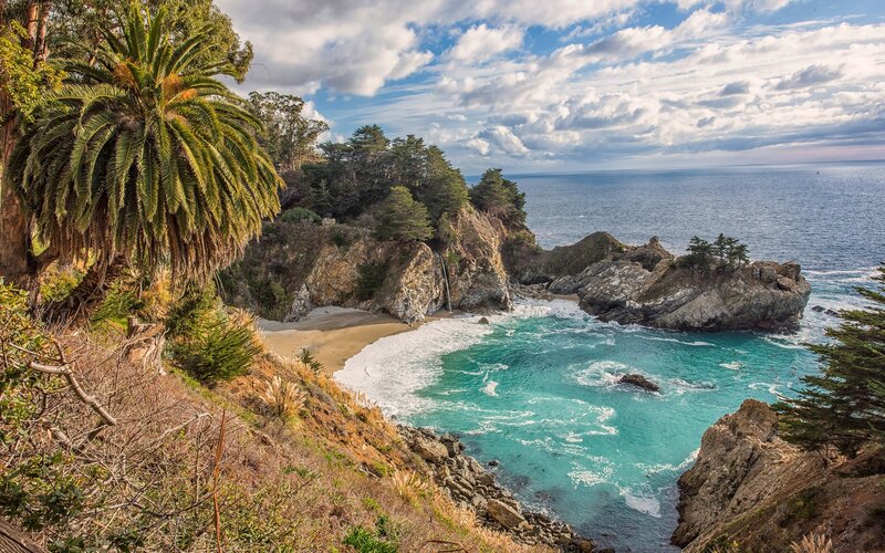 Coastal Cove with Waterfall — Blue, Serene, Afternoon, Photograph, Palm Tree, Ocean