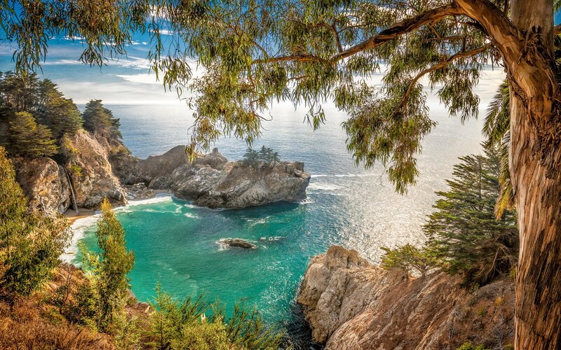 Coastal Cove with Waterfall — Blue, Serene, Afternoon, Photograph, Trees, Rocks