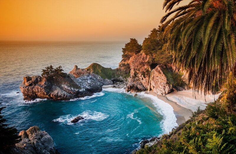 Coastal Cove with Waterfall — Blue, Serene, Sunset, Photograph, Palm Tree, Rock Formation