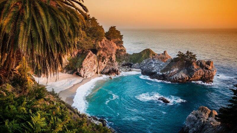 Coastal Cove with Waterfall — Blue, Serene, Sunset, Photograph, Palm Tree, Rock Formations, Ocean