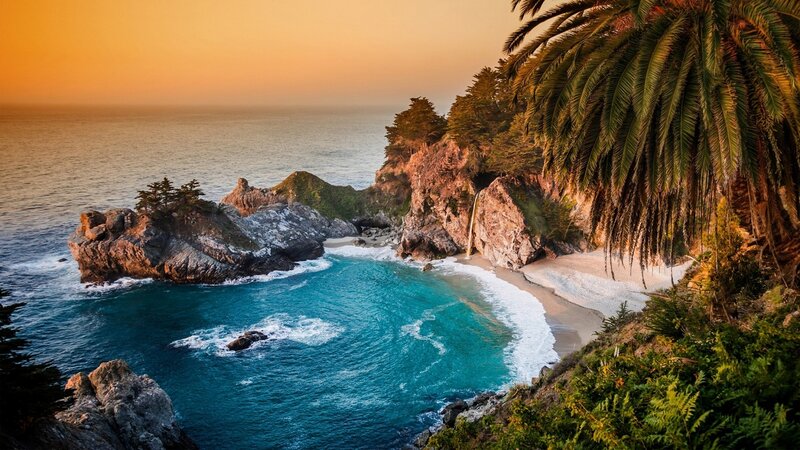 Coastal Cove with Waterfall — Blue, Serene, Sunset, Photograph, Palm Tree, Rock Formations
