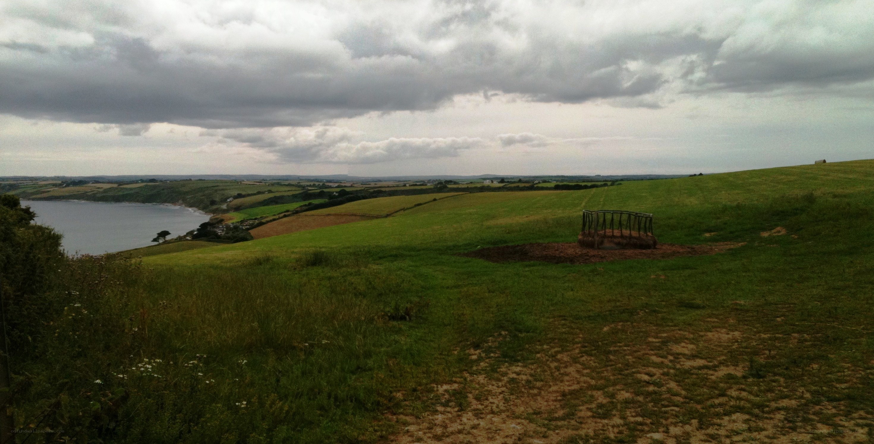 coastal fields under cloudy sky