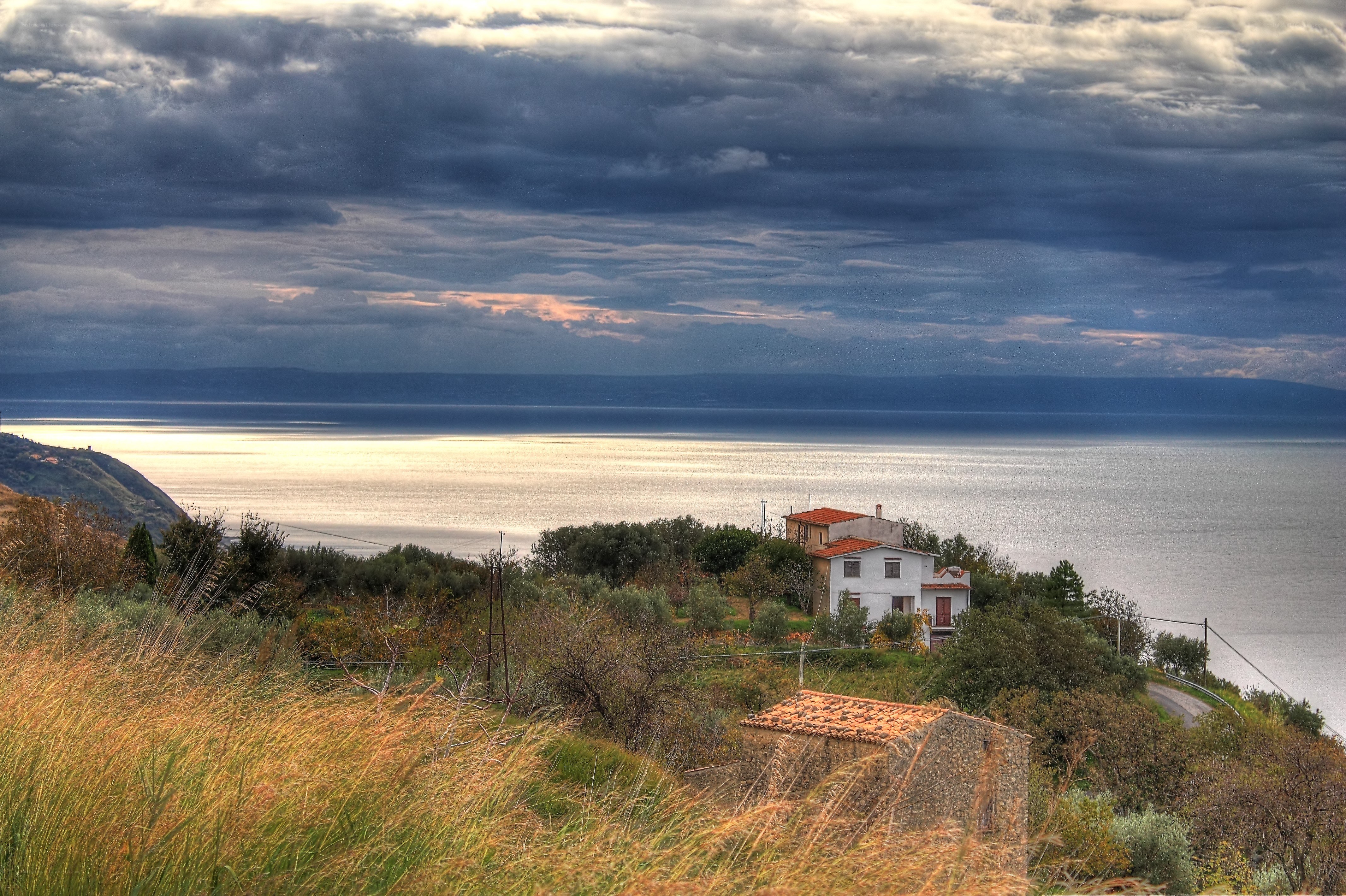 Coastal house under stormy sky