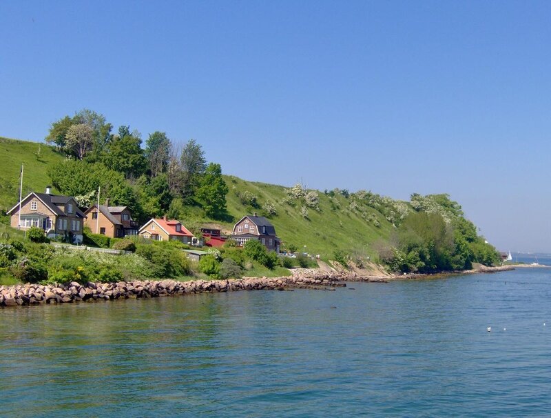 Coastal houses on a green hill