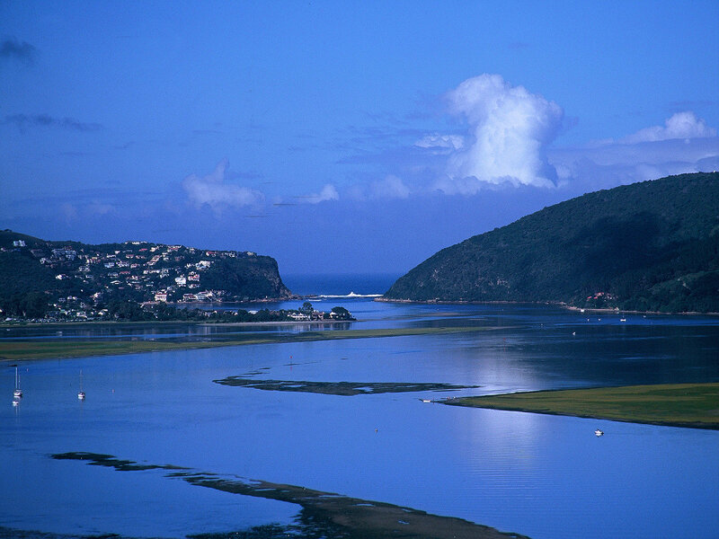 coastal inlet with hills and boats