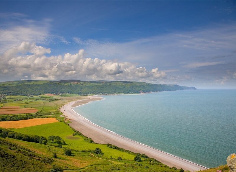 coastal landscape with beach and hills