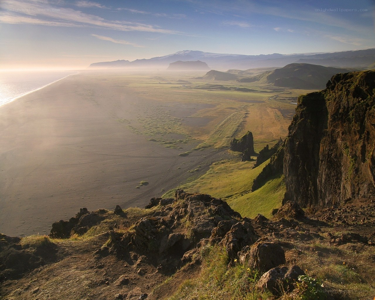 coastal landscape with black sand beach