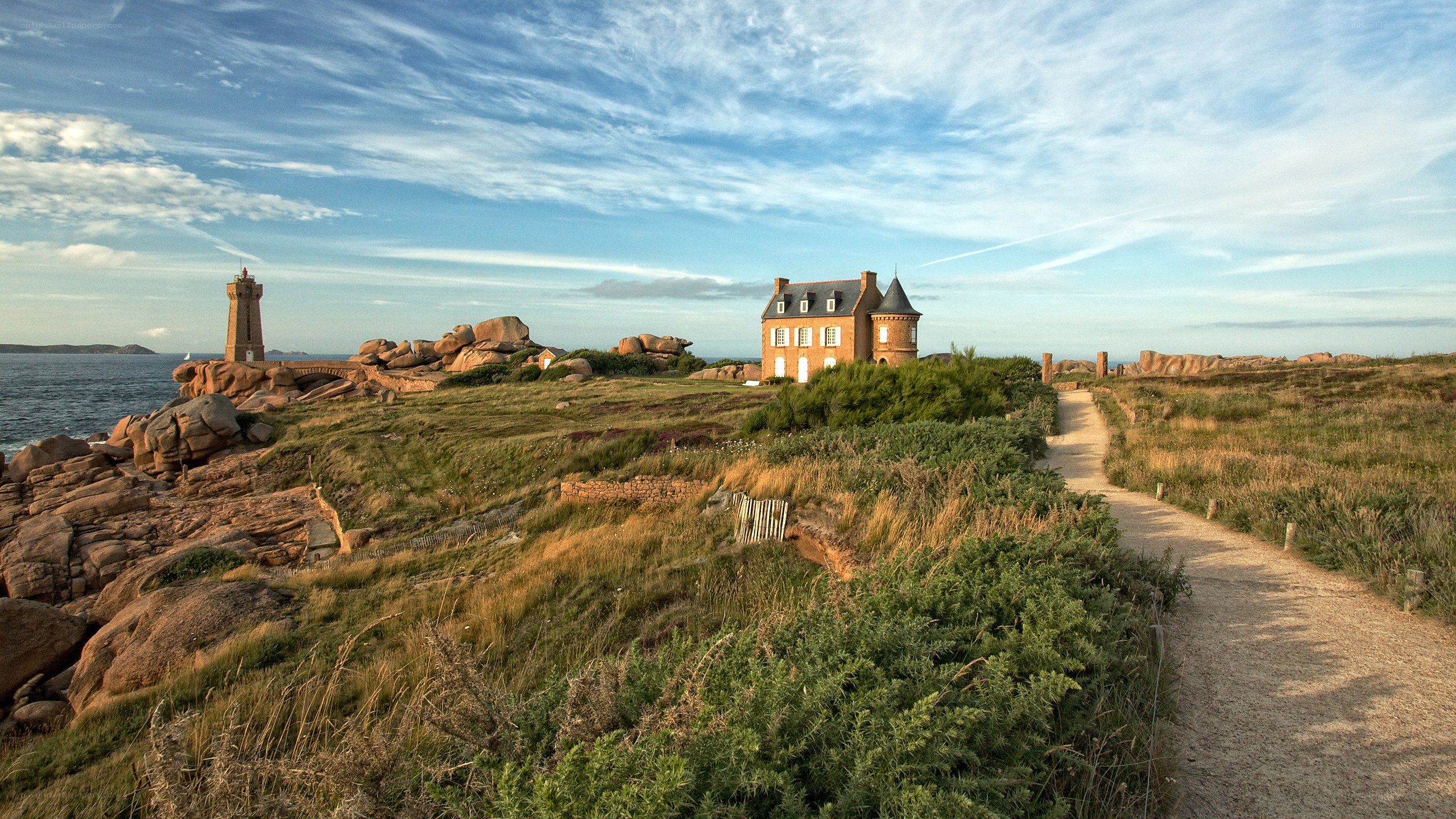 Coastal path with lighthouse and house