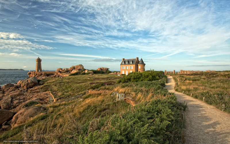 Coastal path with lighthouse and house