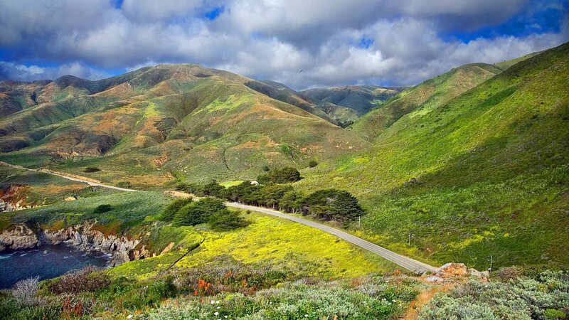 coastal road through green hills