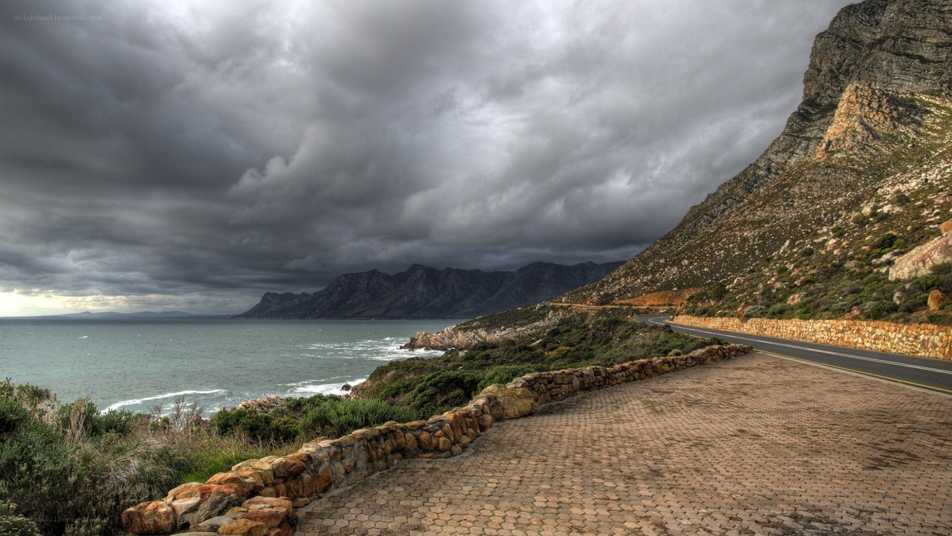 coastal road under stormy sky