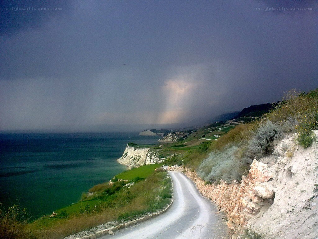 Coastal road under stormy sky