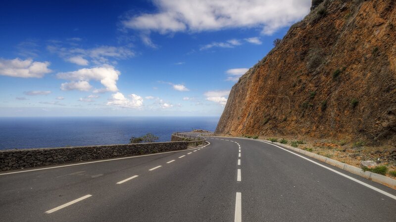 Coastal Road Winding Along Cliff — Blue