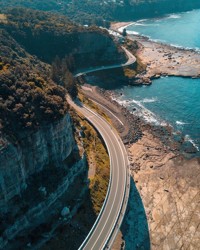 Coastal Road Winding Along Cliffs — Blue