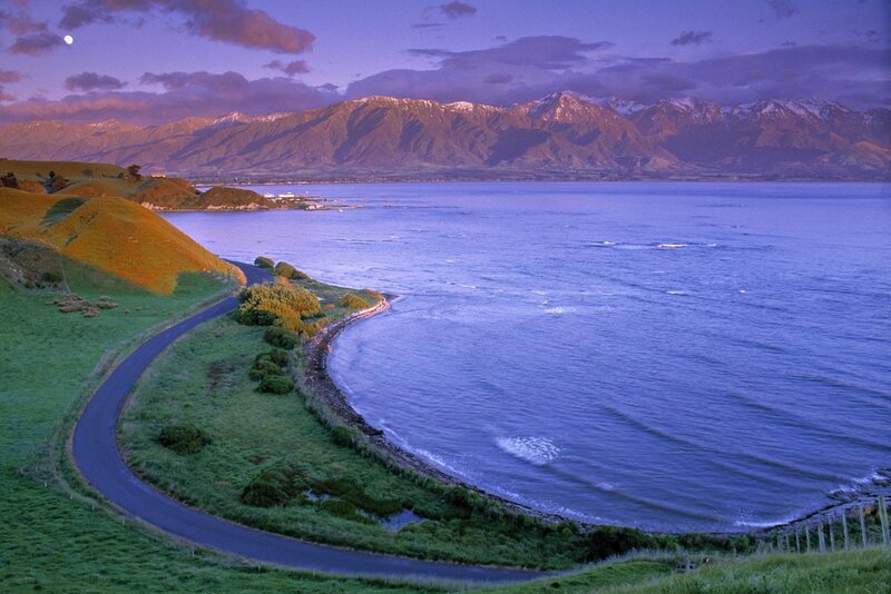 coastal road with mountains at dusk
