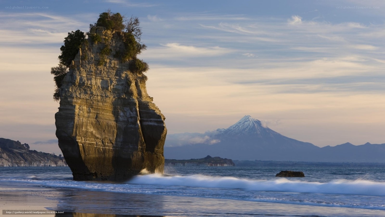 Coastal rock formation with mountain view