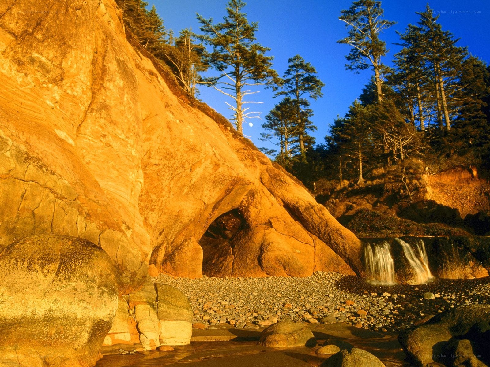 coastal rock formation with waterfall