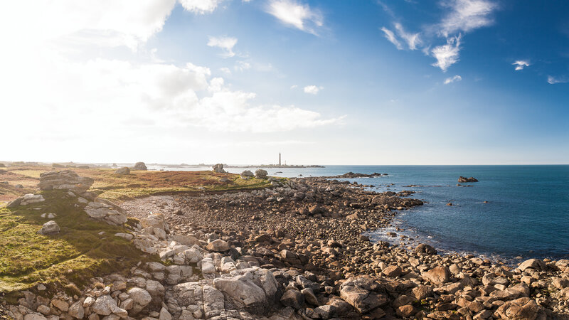 Coastal Rocks and Lighthouse — Blue, Serene, Afternoon, Photograph, Ocean