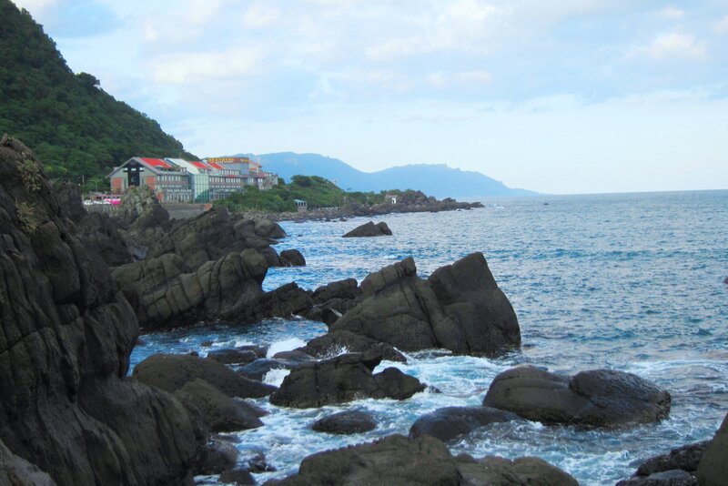 Coastal Rocks and Ocean — Blue, Serene, Afternoon, Photograph, Building