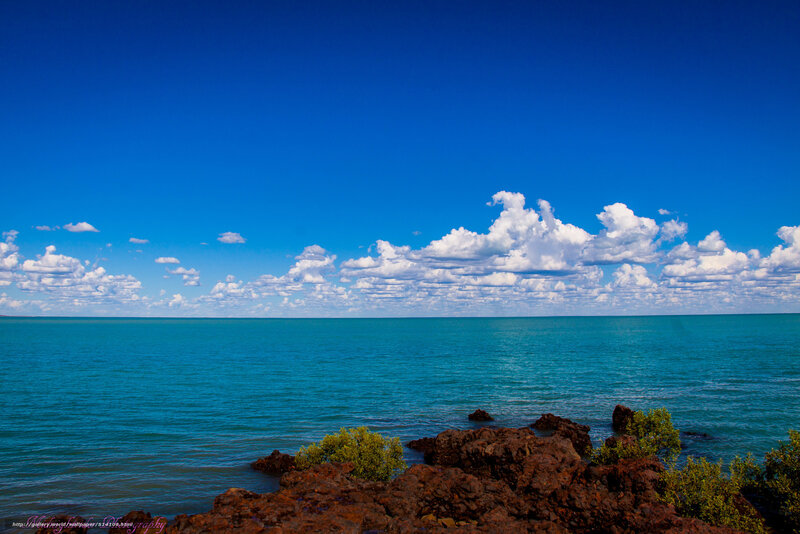 Coastal rocks under blue sky