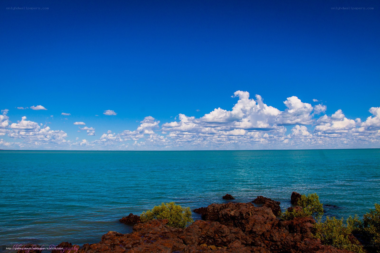 Coastal rocks under blue sky
