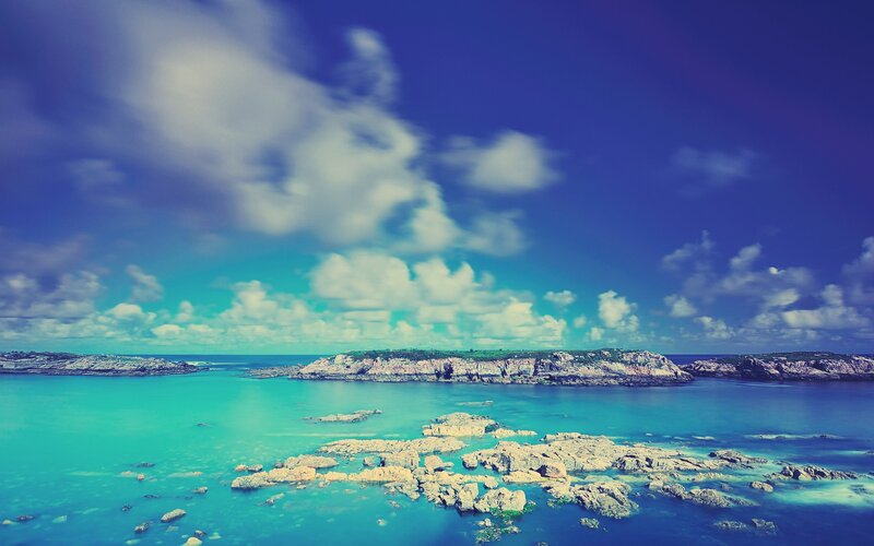 Coastal rocks under blue sky