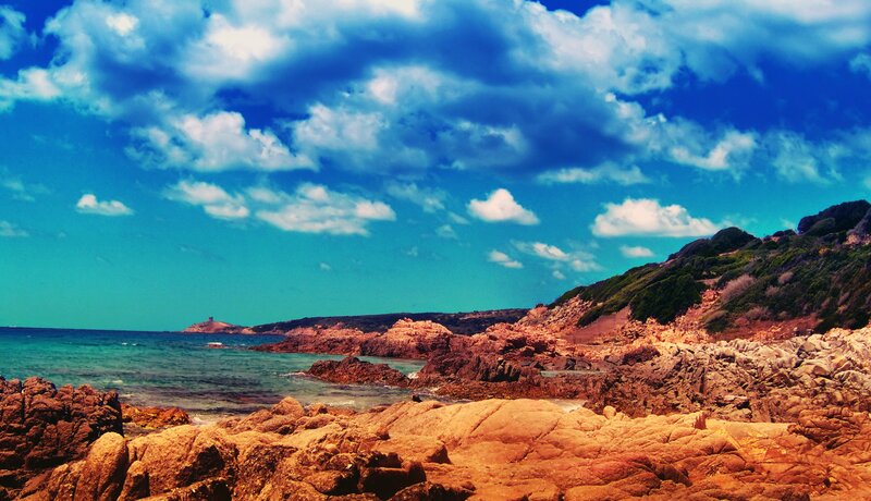 coastal rocks under blue sky