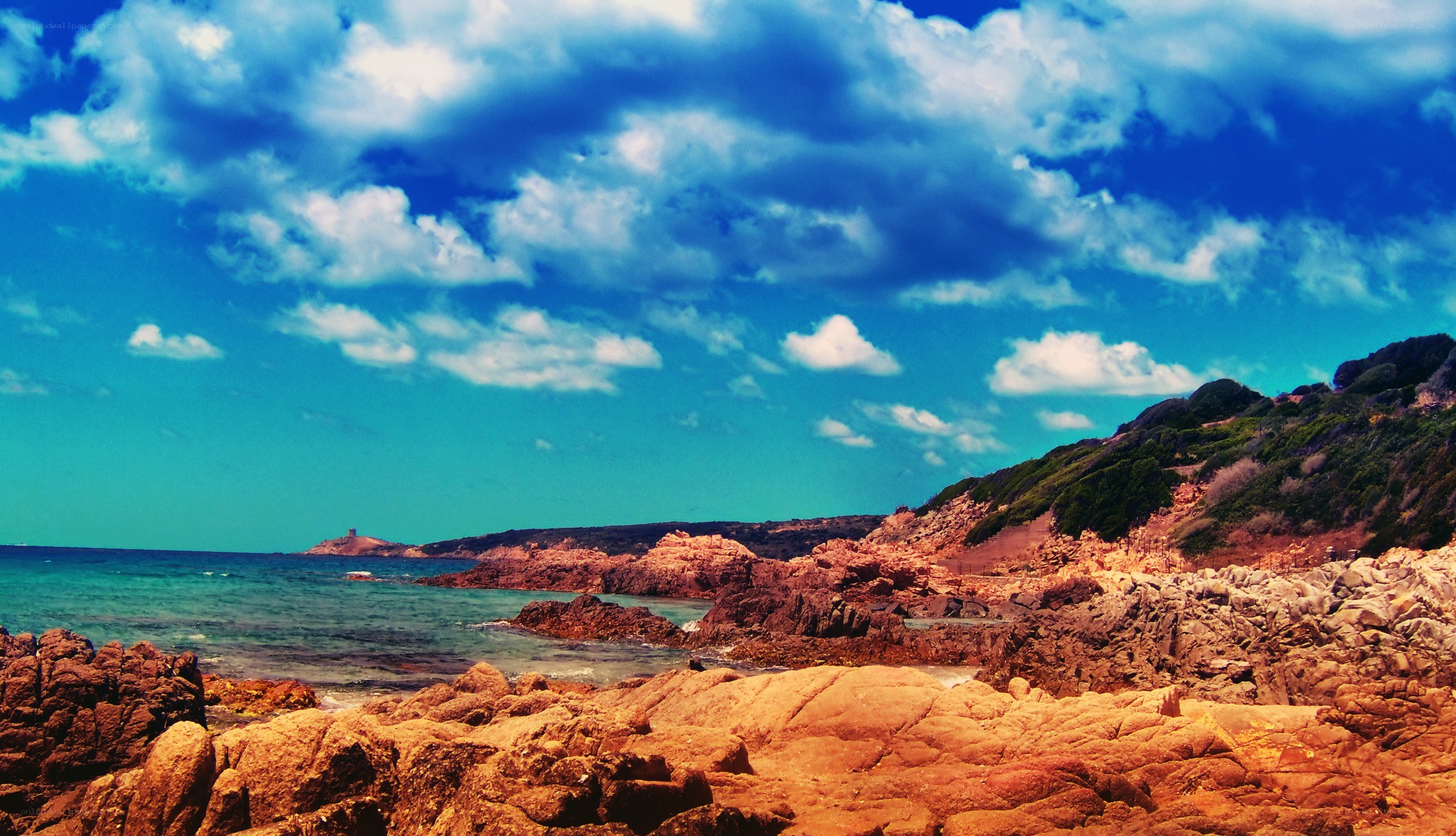 coastal rocks under blue sky