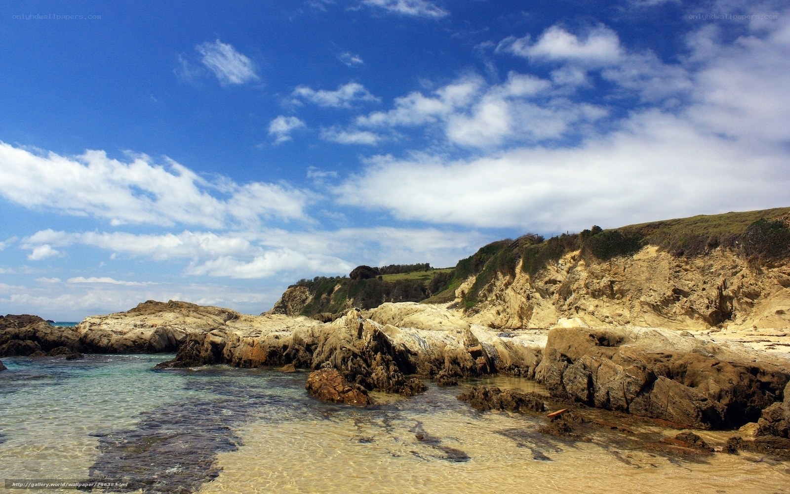 coastal rocks under blue sky