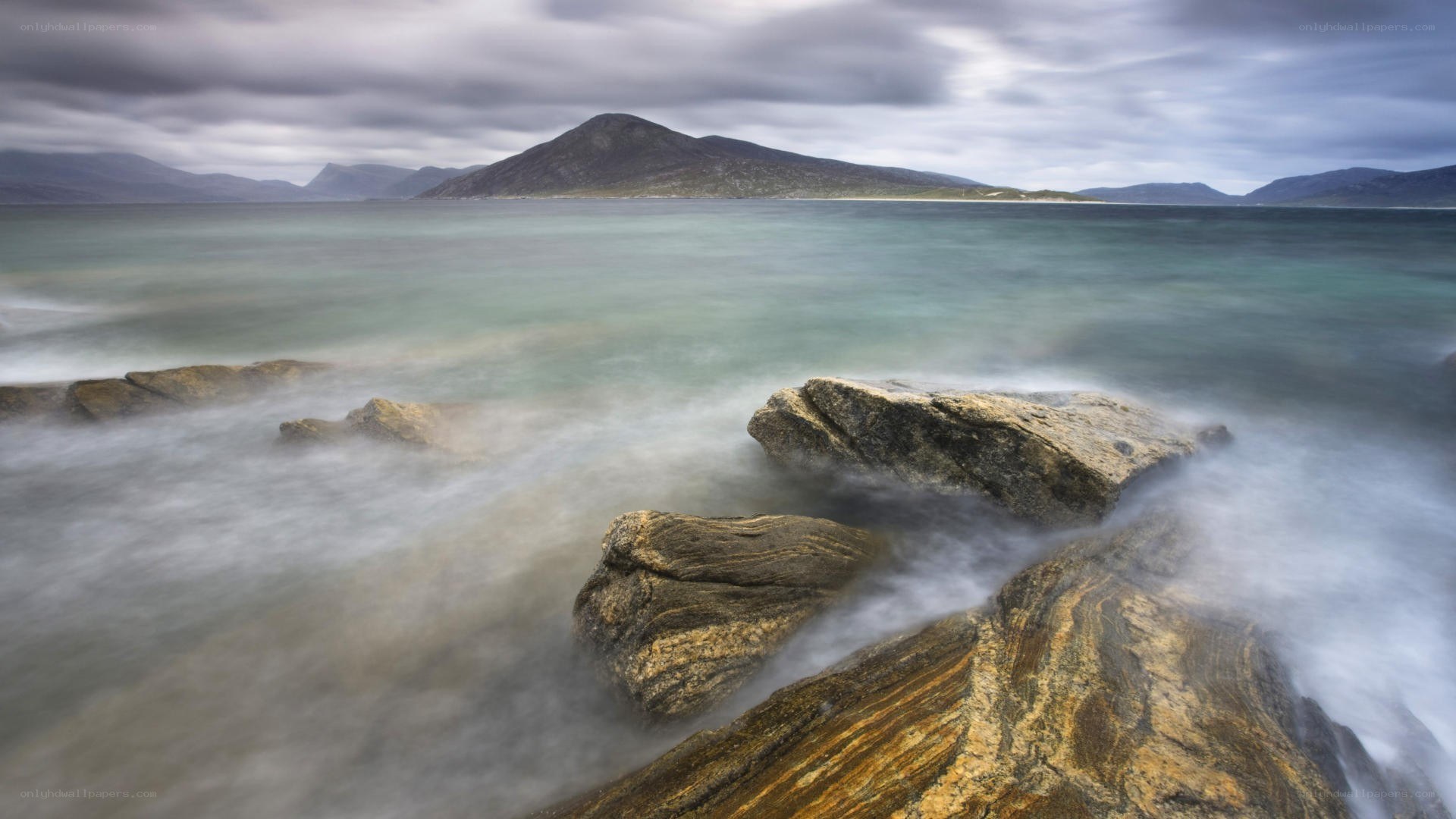 coastal rocks under cloudy sky