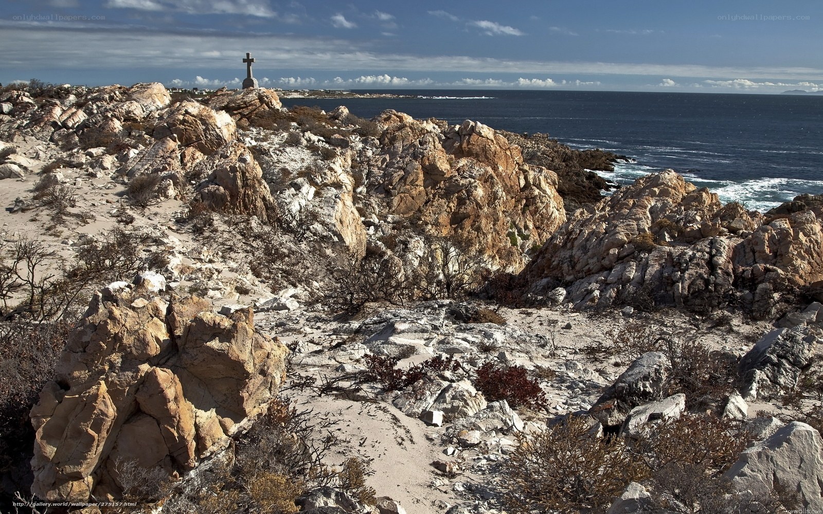 coastal rocks with cross monument