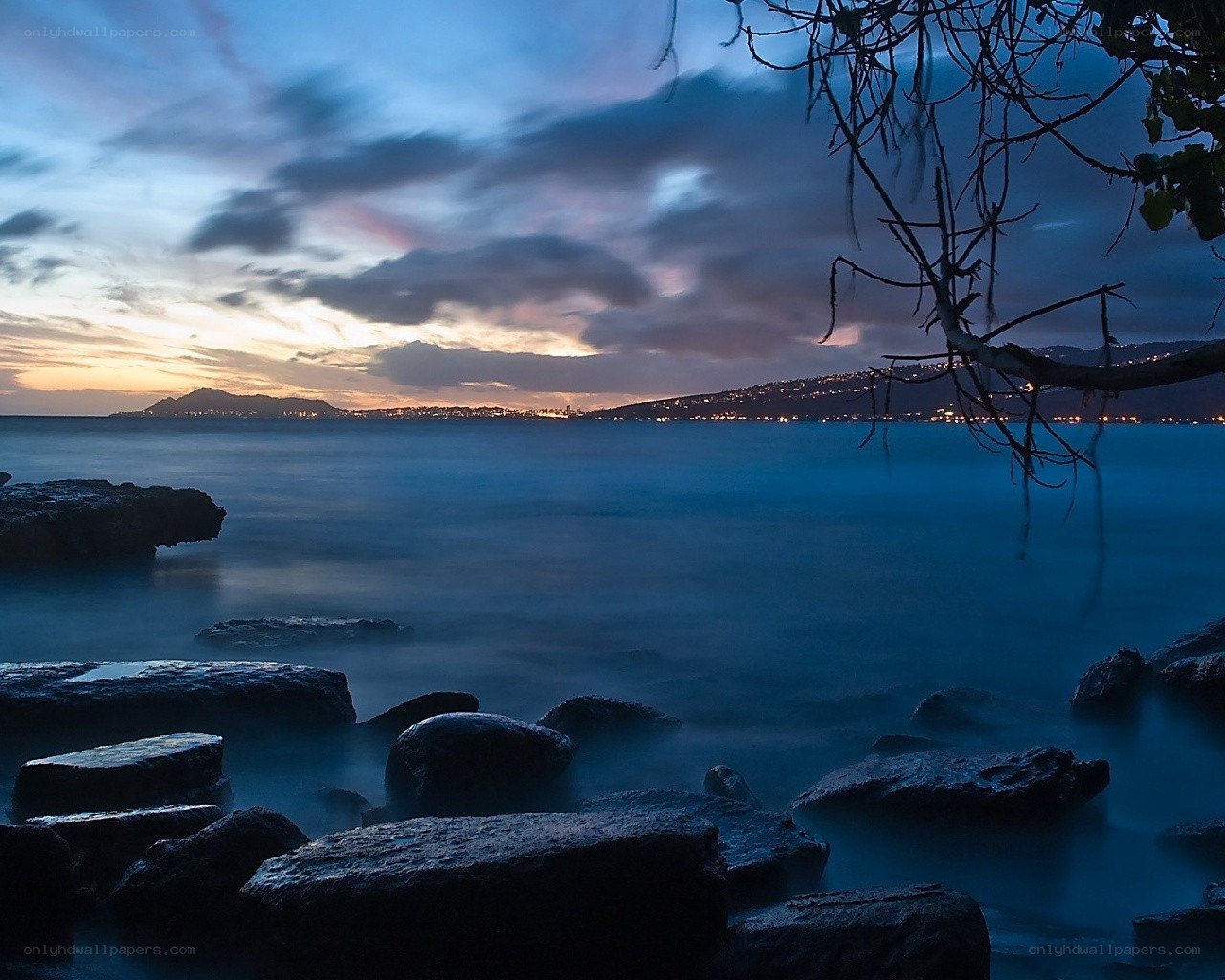 coastal sunset with city lights