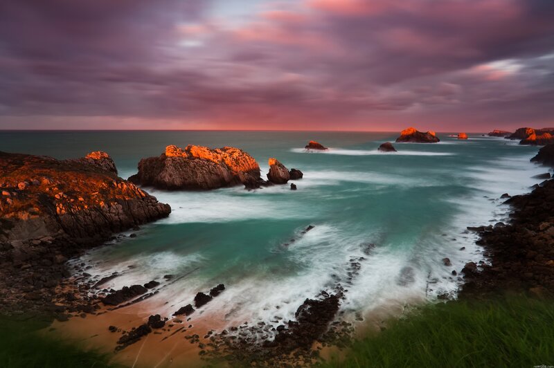 Coastal sunset with rocky outcrops