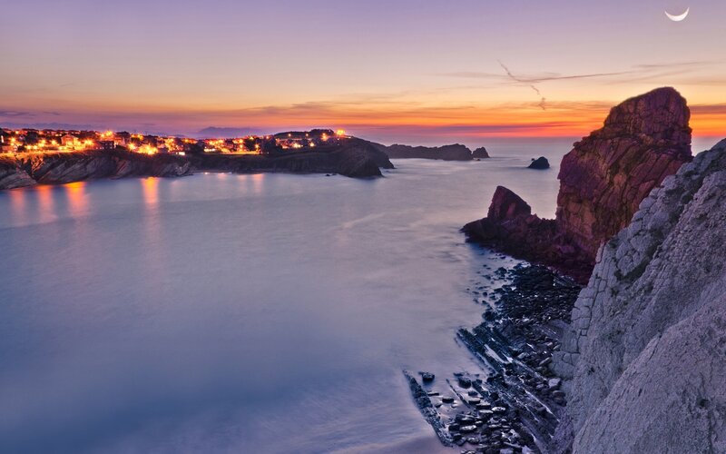 Coastal Town at Dusk — Purple, Serene, Sunset, Photograph, Moon, Cliffs