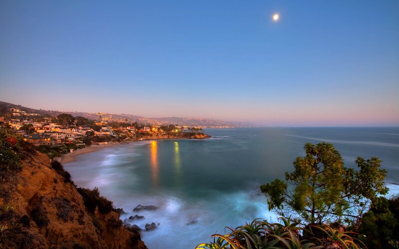 coastal town at dusk with moon