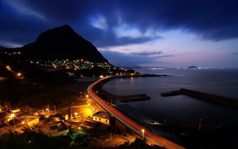 coastal town at night with light trails