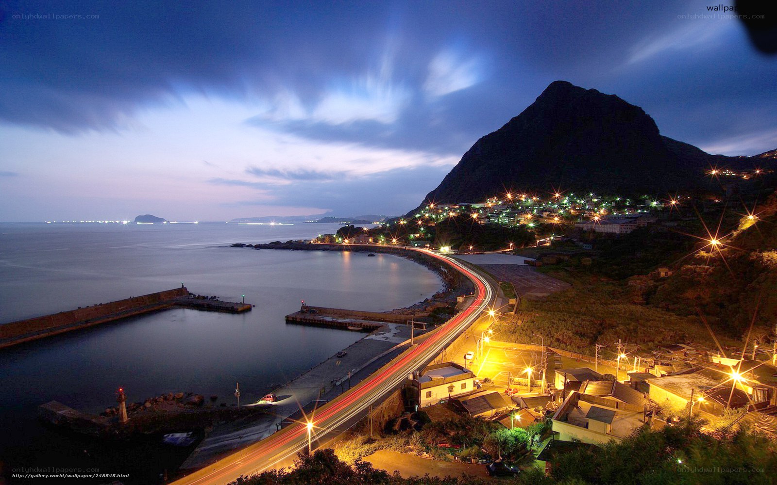 Coastal town at night with light trails