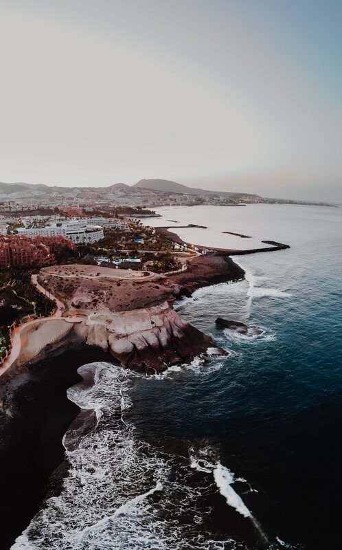 Coastal Town at Sunset — Blue, Serene, Photograph, Ocean, Cliffs, Buildings