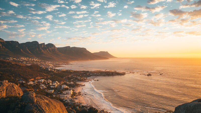 Coastal Town at Sunset — Orange, Serene, Photograph, Mountains, Ocean, Beach