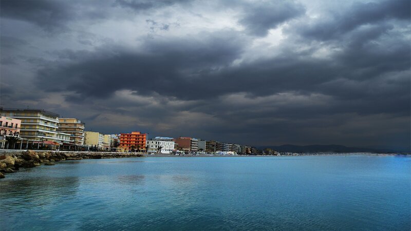 Coastal Town under Storm Clouds — Blue, Dramatic