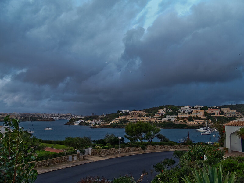 Coastal Town under Storm Clouds