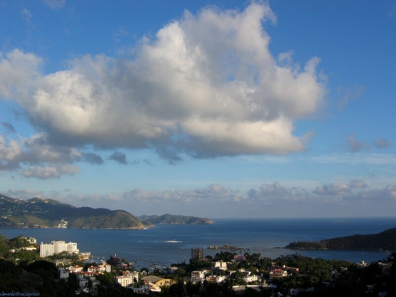 Coastal town with bay and hills