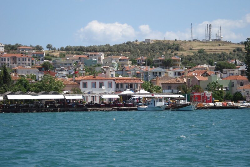 Coastal town with boats and hill