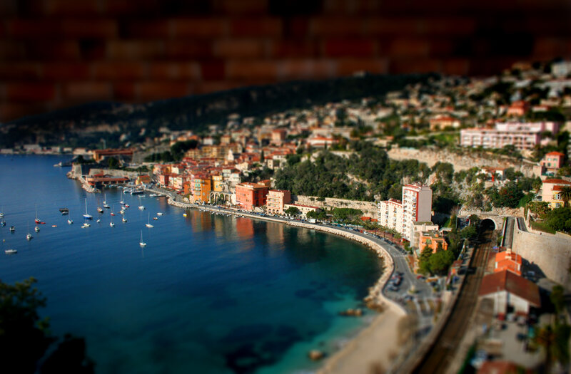 coastal town with boats and hills