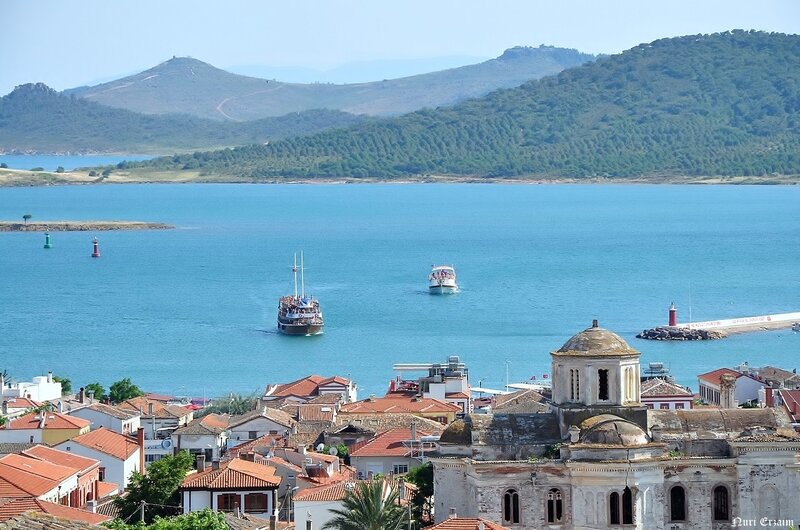 coastal town with boats and mountains